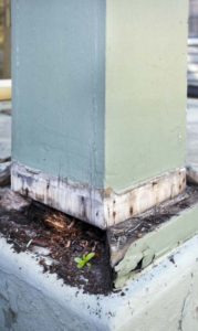 Termite damage around an exterior post.