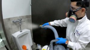 Image of our technician disinfecting a bathroom.