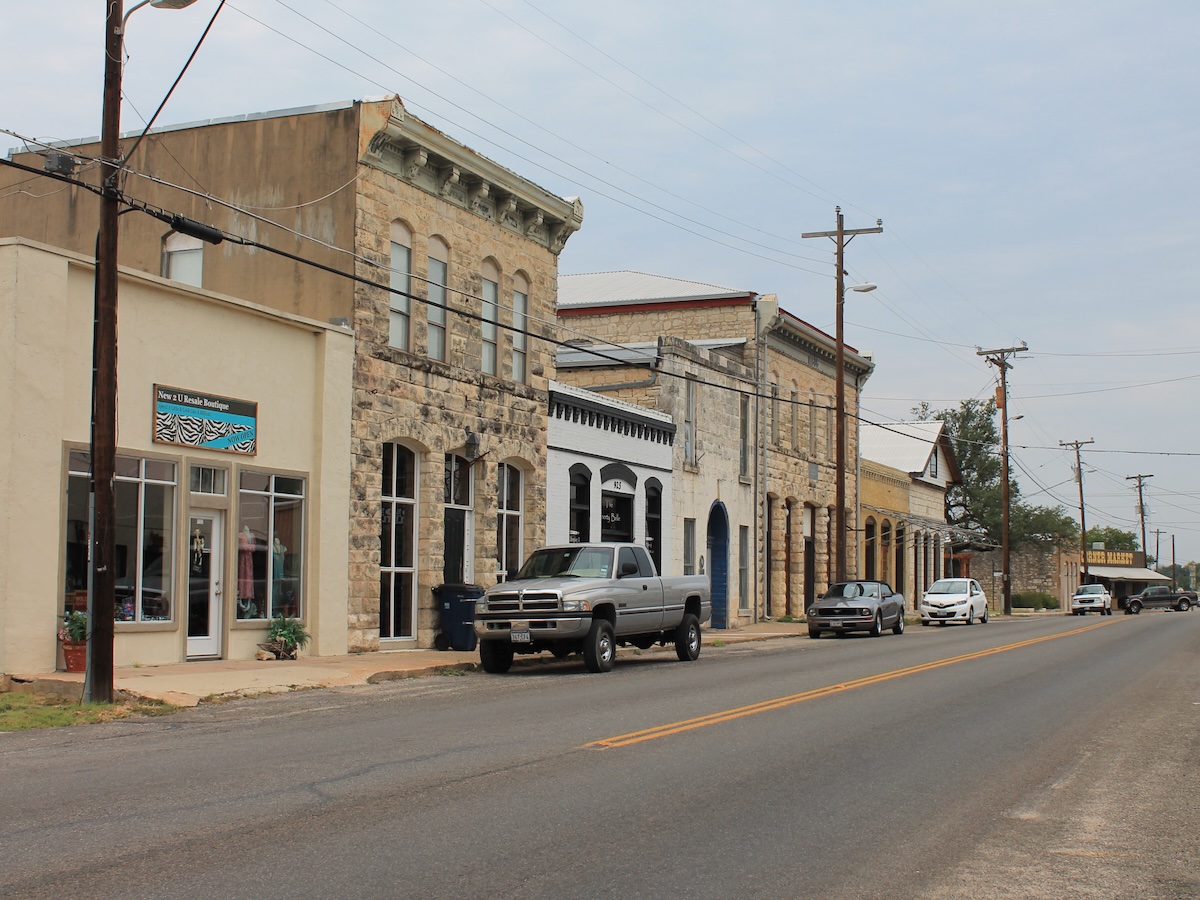 Termite Control Service in Liberty Hill, Texas Historic downtown storefronts on a quiet street with parked cars