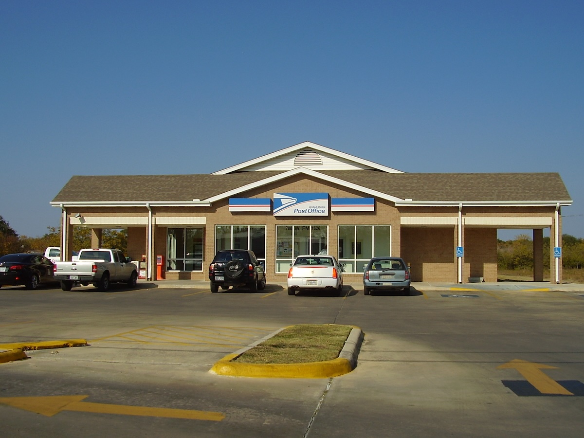 Termite Control Service in Manchaca, Texas Commercial building with parking lot and clear blue sky