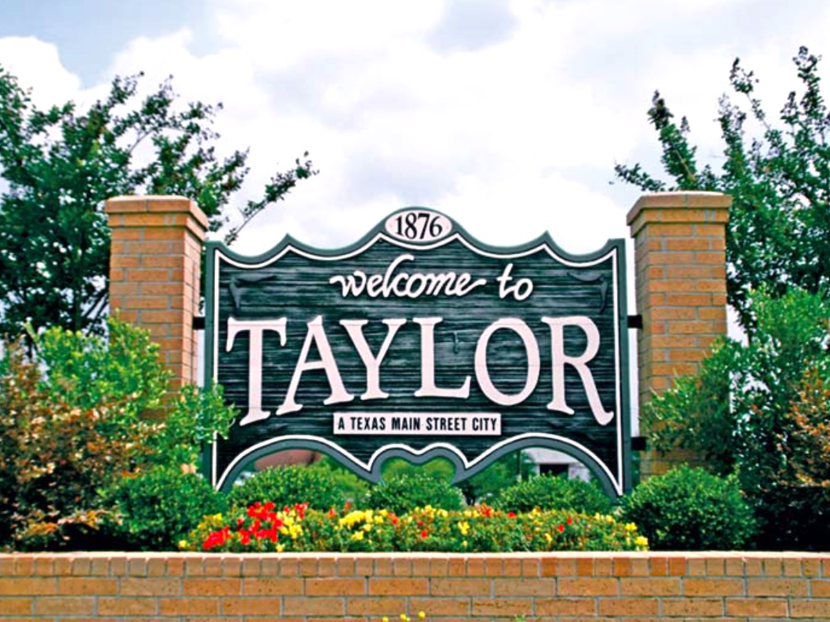 Termite Control Service in Taylor, Texas Welcome sign to Taylor, Texas, with landscaping and the town's founding year, 1876